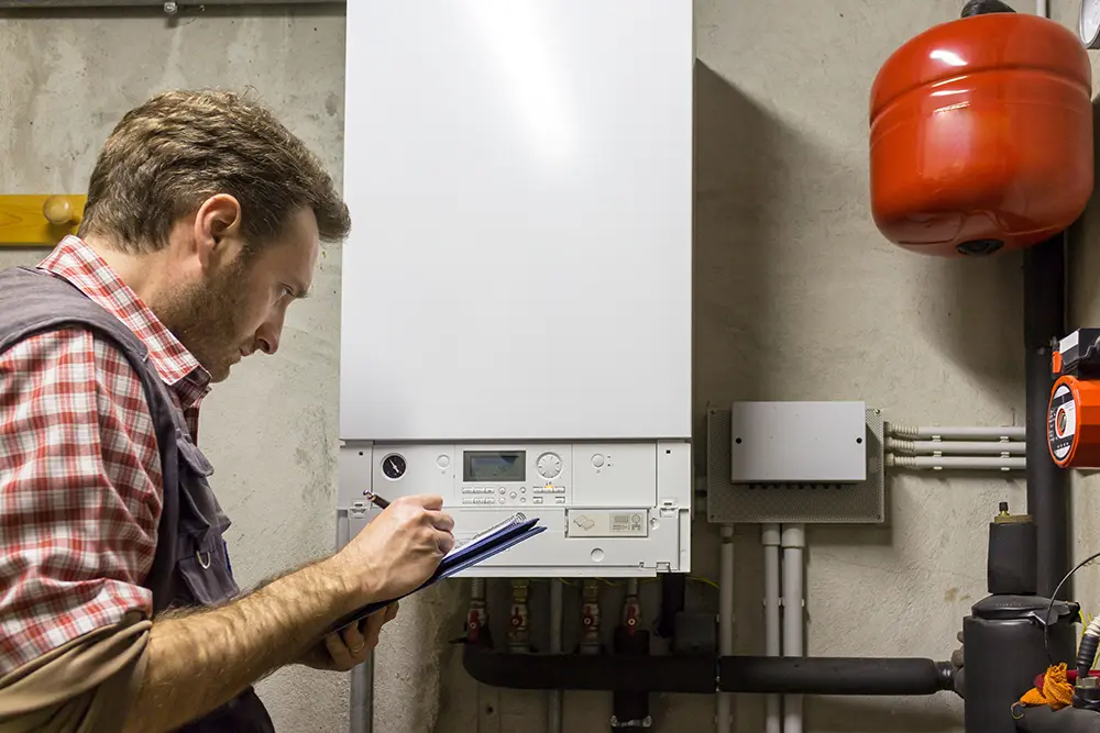 Plumber inspecting tankless water header